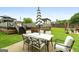 Outdoor patio with an umbrella-covered dining set, wooden deck with pergola, and well-manicured lawn for gatherings at 1195 New Hope Rd, Locust Grove, GA 30248