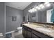 Well-lit bathroom with double sinks, tile floors, and a large mirror at 1195 New Hope Rd, Locust Grove, GA 30248