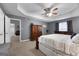 Large main bedroom featuring tray ceilings, carpet, and a ceiling fan at 1195 New Hope Rd, Locust Grove, GA 30248