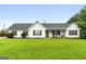 Inviting single story home with lush green lawn and welcoming covered porch at 1195 New Hope Rd, Locust Grove, GA 30248