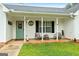 Charming front porch with rocking chairs and a decorative welcome sign on the front door at 1195 New Hope Rd, Locust Grove, GA 30248