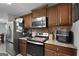 Modern kitchen featuring stainless steel appliances, custom cabinets, and granite countertops at 1195 New Hope Rd, Locust Grove, GA 30248