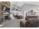 Cozy living room with a stone fireplace, plush seating, and an open dining area at 1195 New Hope Rd, Locust Grove, GA 30248