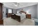This main bedroom has a trey ceiling, carpeted floors, and ceiling fan at 1195 New Hope Rd, Locust Grove, GA 30248