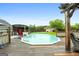 The above-ground pool has a wooden deck, red fridge, and wooden fence at 1195 New Hope Rd, Locust Grove, GA 30248