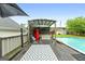 Backyard pool with an outdoor patio, red fridge, and wooden deck at 1195 New Hope Rd, Locust Grove, GA 30248