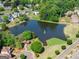 Aerial view of a community pond, gazebo, fountain, and walking paths in a picturesque setting at 4680 Brighton Lake Dr, Cumming, GA 30040