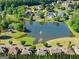 Aerial view of a community pond with a fountain, gazebo, and manicured green space in a peaceful setting at 4680 Brighton Lake Dr, Cumming, GA 30040