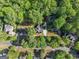 Aerial view of the property showcasing the neighborhood, lush greenery, and nearby amenities at 4680 Brighton Lake Dr, Cumming, GA 30040