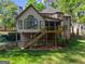 Spacious backyard with a deck, patio, and stairs leading to the upper level at 4680 Brighton Lake Dr, Cumming, GA 30040
