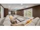 Finished basement showcasing a large sectional and sliding doors at 4680 Brighton Lake Dr, Cumming, GA 30040