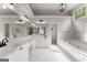 Bright bathroom featuring double sinks, bathtub, and a large vanity mirror at 4680 Brighton Lake Dr, Cumming, GA 30040