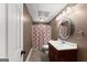 Traditional bathroom featuring a single sink vanity, decorative mirror, and patterned shower curtain at 4680 Brighton Lake Dr, Cumming, GA 30040