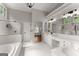 Bathroom featuring white tile, a separate tub, and a glass shower at 4680 Brighton Lake Dr, Cumming, GA 30040