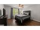 Bedroom featuring hardwood floors, a TV, and a large window with curtains at 4680 Brighton Lake Dr, Cumming, GA 30040
