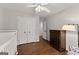 Bedroom featuring hardwood floors, a double closet, crib, and a dresser at 4680 Brighton Lake Dr, Cumming, GA 30040