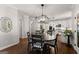 Bright dining area with modern light fixture, hardwood floors and an open transition to the kitchen at 4680 Brighton Lake Dr, Cumming, GA 30040