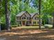 Charming two-story brick home with long driveway and mature trees at 4680 Brighton Lake Dr, Cumming, GA 30040