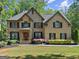 Charming two-story brick home with manicured lawn, inviting entrance, and professionally landscaped yard at 4680 Brighton Lake Dr, Cumming, GA 30040