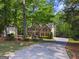 Charming two-story brick home with long driveway and mature trees at 4680 Brighton Lake Dr, Cumming, GA 30040
