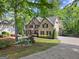Charming two-story brick home with mature trees and landscaped yard at 4680 Brighton Lake Dr, Cumming, GA 30040