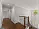 Upstairs hallway with wood floors, staircase and a view of the front door at 4680 Brighton Lake Dr, Cumming, GA 30040