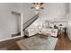 Open-concept living room featuring hardwood floors and staircase adjacent to the kitchen at 4680 Brighton Lake Dr, Cumming, GA 30040