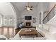 Spacious living room with high ceilings, a brick fireplace, built-in bookshelves, and hardwood floors at 4680 Brighton Lake Dr, Cumming, GA 30040