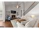 Bright living room featuring a fireplace, hardwood floors, vaulted ceilings, and staircase at 4680 Brighton Lake Dr, Cumming, GA 30040