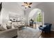 Spacious living room featuring hardwood floors, an archway, and a sunroom with large windows at 4680 Brighton Lake Dr, Cumming, GA 30040