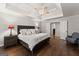Bright main bedroom with tray ceiling, fan, hardwood floors, and neutral decor at 4680 Brighton Lake Dr, Cumming, GA 30040