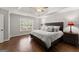 Main bedroom with a tray ceiling, hardwood floors, and a large window at 4680 Brighton Lake Dr, Cumming, GA 30040