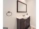 Bathroom featuring a modern vanity, framed mirror, and sleek fixtures, providing a clean and stylish aesthetic at 5940 Plantation Dr, Roswell, GA 30075