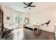 Bright bedroom featuring hardwood floors, a cozy chair, and a wolf decal on the wall at 5940 Plantation Dr, Roswell, GA 30075
