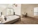 Spacious bedroom with neutral carpet, large window and a desk near the entrance at 5940 Plantation Dr, Roswell, GA 30075
