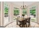 Sun-filled dining area with large windows overlooking the lush backyard at 5940 Plantation Dr, Roswell, GA 30075