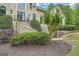 Beautiful landscaped front yard featuring a stairway to the home's entrance and mature plantings at 5940 Plantation Dr, Roswell, GA 30075