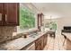 Bright eat-in kitchen boasts granite counters, stainless steel appliances, and view of the backyard at 5940 Plantation Dr, Roswell, GA 30075