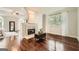 Open living room featuring hardwood floors and a fireplace at 5940 Plantation Dr, Roswell, GA 30075
