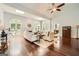 Bright living room with hardwood floors, high ceilings, fireplace, and multiple arched windows at 5940 Plantation Dr, Roswell, GA 30075