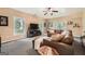 Inviting living room with a plush leather sectional, large windows, and a relaxed atmosphere, perfect for entertaining at 5940 Plantation Dr, Roswell, GA 30075