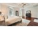 Sun-filled main bedroom showcasing large windows, hardwood floors, and trey ceiling at 5940 Plantation Dr, Roswell, GA 30075