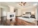 Spacious main bedroom featuring a fireplace, hardwood floors and tray ceilings at 5940 Plantation Dr, Roswell, GA 30075