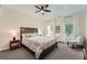 Serene main bedroom with a comfortable bed, soft lighting, and large windows, offering a relaxing retreat at 5940 Plantation Dr, Roswell, GA 30075