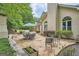 Charming patio with stone flooring, outdoor seating, and lush greenery, ideal for enjoying outdoor living at 5940 Plantation Dr, Roswell, GA 30075