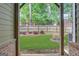 A covered patio presents a manicured backyard with lush lawn, landscaping, and privacy fencing at 1300 Hopkins Dr, Decatur, GA 30033