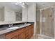 Bathroom featuring a double sink vanity with granite countertop and a tiled glass-enclosed shower at 1300 Hopkins Dr, Decatur, GA 30033