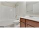 Bathroom features a tub/shower combo, toilet, and a vanity with sink and traditional wood cabinets at 1300 Hopkins Dr, Decatur, GA 30033