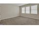 A carpeted bedroom with neutral walls and multiple windows providing natural light, perfect for relaxation at 1300 Hopkins Dr, Decatur, GA 30033