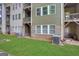 A view of the building's exterior showcasing well-maintained lawn, brick accents, and neutral siding at 1300 Hopkins Dr, Decatur, GA 30033
